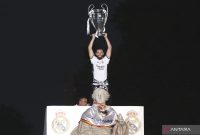 Nacho Fernandez saat selebrasi mengangkat piala Champions. (Photo by Thomas COEX / AFP)