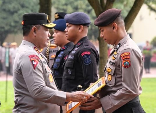 Kapolda Sumut Irjen Pol Whisnu Hermawan (kiri) saat menyerahkan piagam penghargaan kepada Briptu Johanes Abdi Negoro Sibarani di Lapangan Apel Mapolda Sumut, Senin (2/12). Foto: Humas Polda Sumut