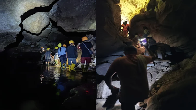 Wisatawan menjelajahi lorong bawah tanah beraliran air di Seribu Goa Banuarea, Humbang Hasundutan, Sumatera Utara, saat aktivitas susur goa (caving) di kawasan goa kapur yang masih alami.