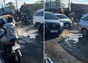 Jalan Veteran Pasar 9 Helvetia Deli Serdang rusak parah dengan banyak lubang besar, menjadi sorotan terkait kondisi infrastruktur Deli Serdang.